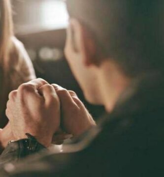 couple holding hands in restaurant