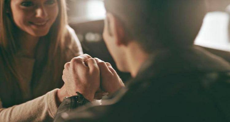 couple holding hands in restaurant